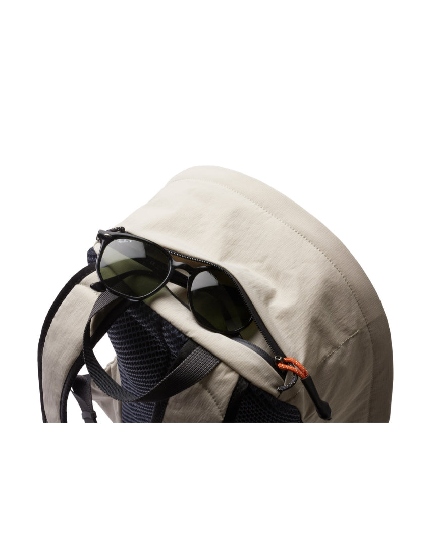 Bellroy Lite Daypack in ash color, showing a sleek, compact backpack with multiple compartments and padded shoulder straps.