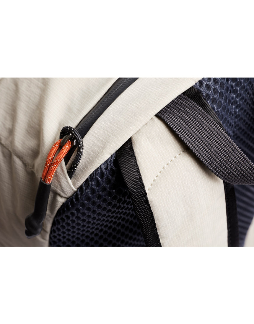 Bellroy Lite Daypack in Ash color, showcasing its sleek, compact design with adjustable straps and multiple storage compartments.