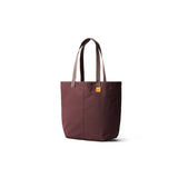 Bellroy Market Tote in burgundy fabric with leather handles, showing its spacious design and stylish craftsmanship.