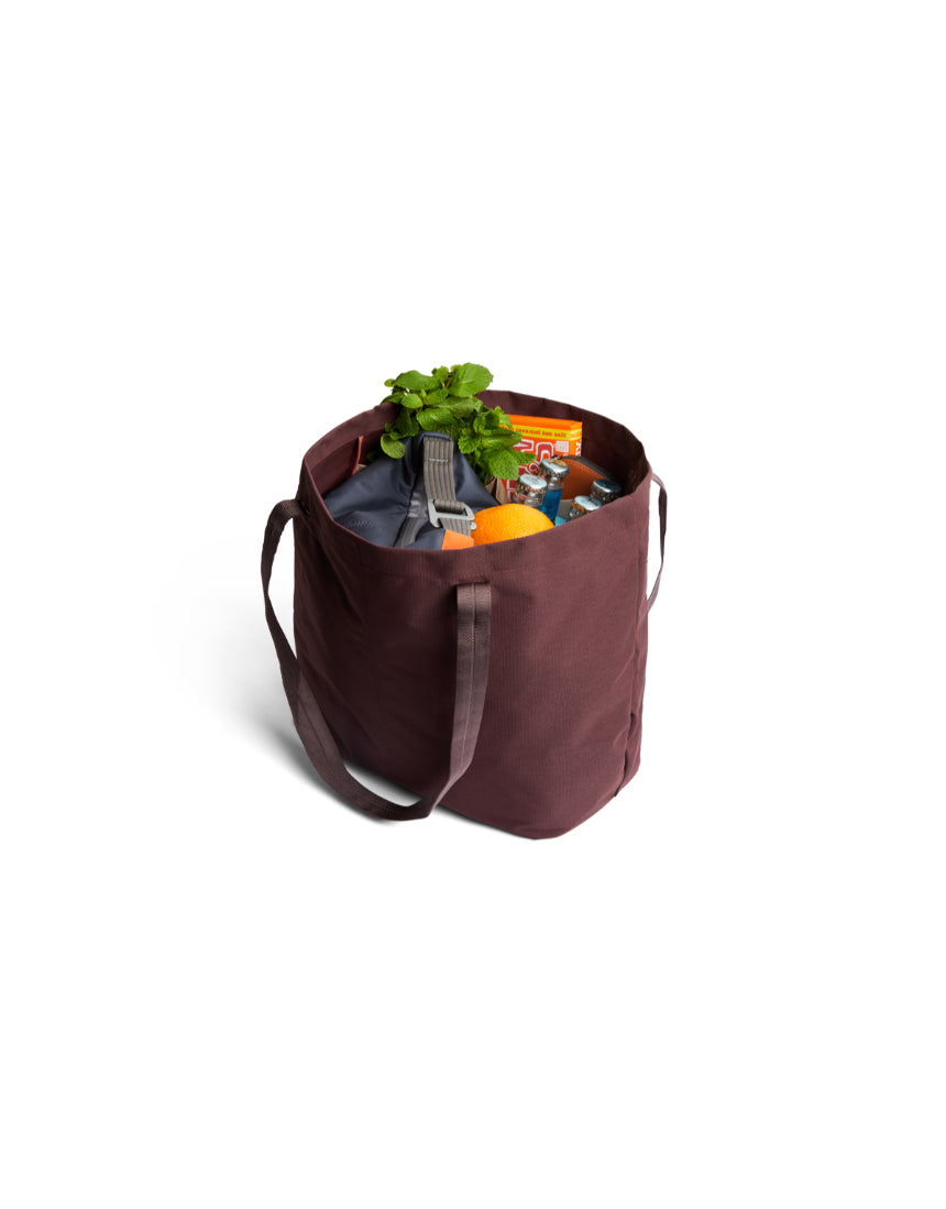 Bellroy Market Tote in burgundy, a stylish and spacious leather bag with handles, perfect for shopping and everyday use.