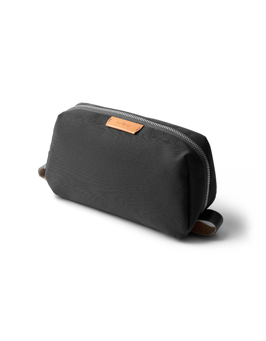 Bellroy Slate toiletry kit with multiple compartments, compact design, and durable material for travel organization.