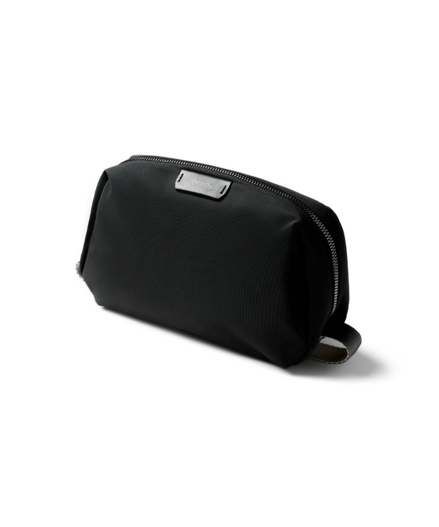 Bellroy black toiletry kit showing compact design with zipper closure and multiple compartments for travel essentials.