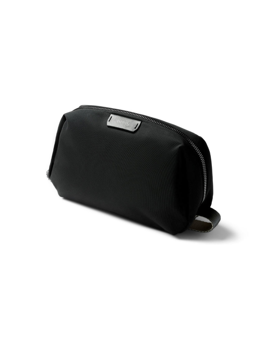 Bellroy black toiletry kit showing compact design with zipper closure and multiple compartments for travel essentials.