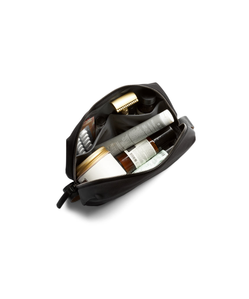 Bellroy black toiletry kit with zipper closure and multiple compartments for organizing grooming essentials.