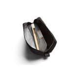 Bellroy black toiletry kit with zippered compartments and durable fabric for organizing travel essentials.
