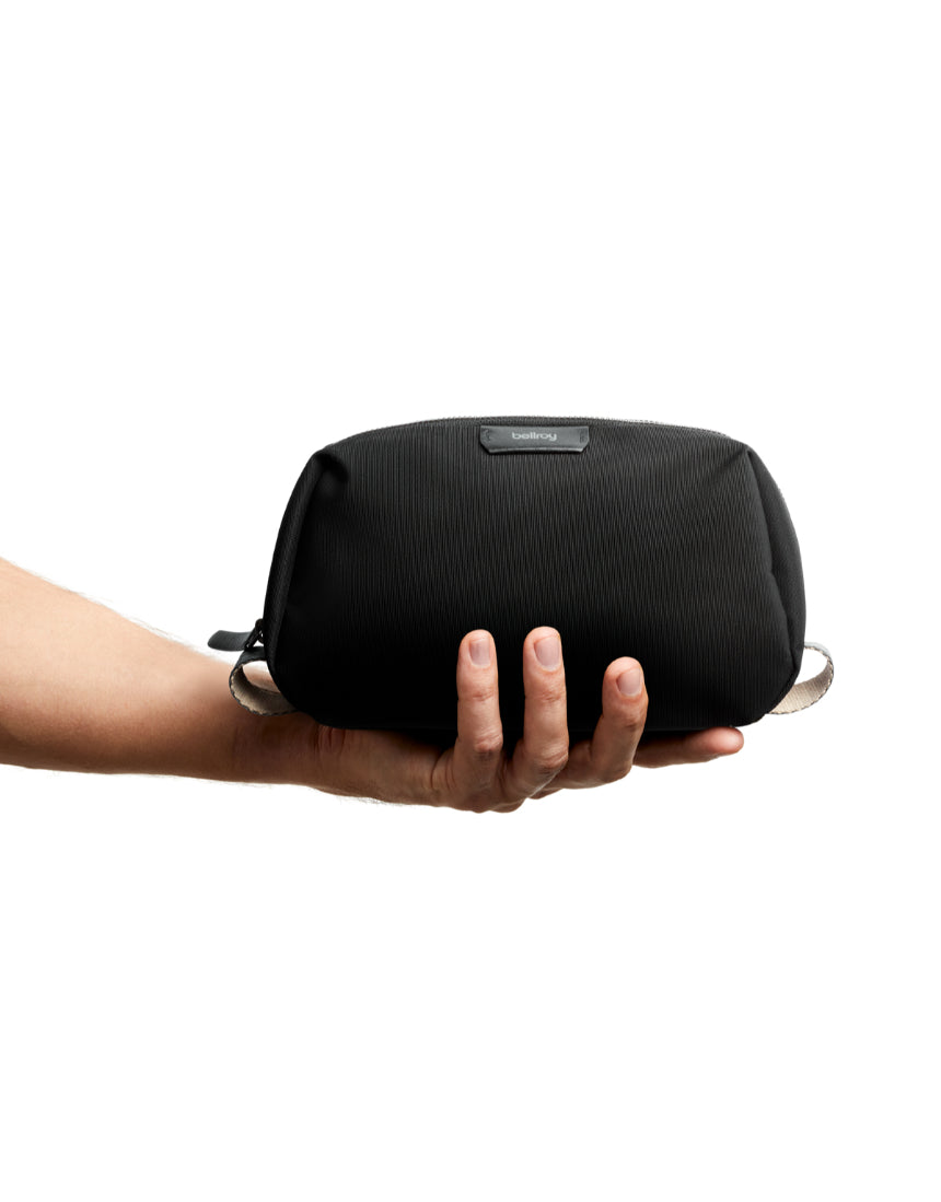 Bellroy black toiletry kit with zipped compartments and compact design, ideal for travel storage of grooming essentials.