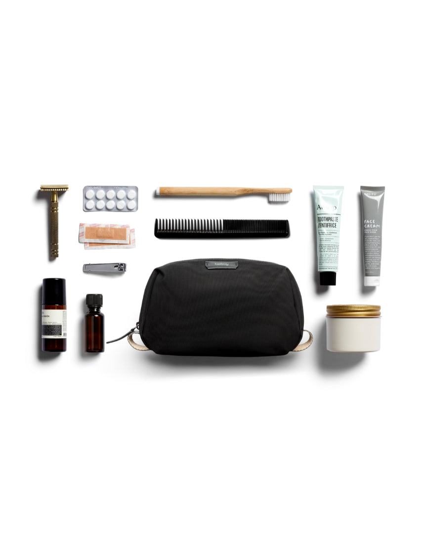 Bellroy black toiletry kit with zipper closure and multiple compartments, designed for organizing travel essentials.