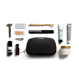 Bellroy black toiletry kit with zipper closure and multiple compartments, designed for organizing travel essentials.