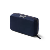 Bellroy Tech Kit in navy with multiple compartments and zippers, designed for organizing tech accessories and cables.