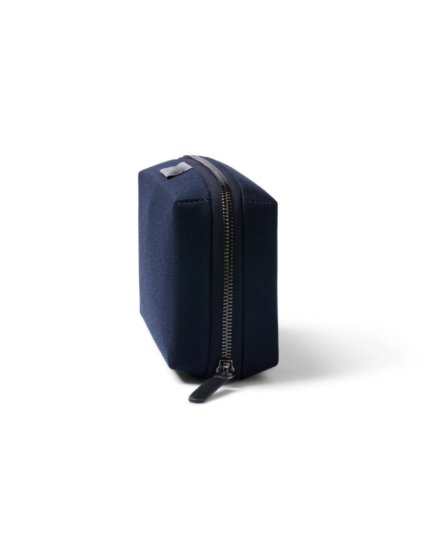 Bellroy Tech Kit in navy with multiple compartments for organizing cables, chargers, and electronic accessories.