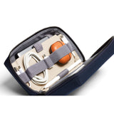 Bellroy Tech Kit in navy with multiple compartments and zippers, designed for organizing cables, chargers, and tech accessories.