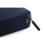 Bellroy Tech Kit in navy, compact organizer with multiple compartments for cables, chargers, and accessories, laid out on a surface.