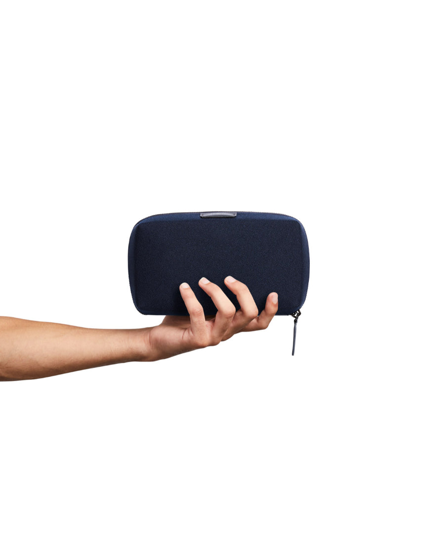 Bellroy Tech Kit in navy, featuring organized compartments and sleek design for storing cables, chargers, and tech accessories.