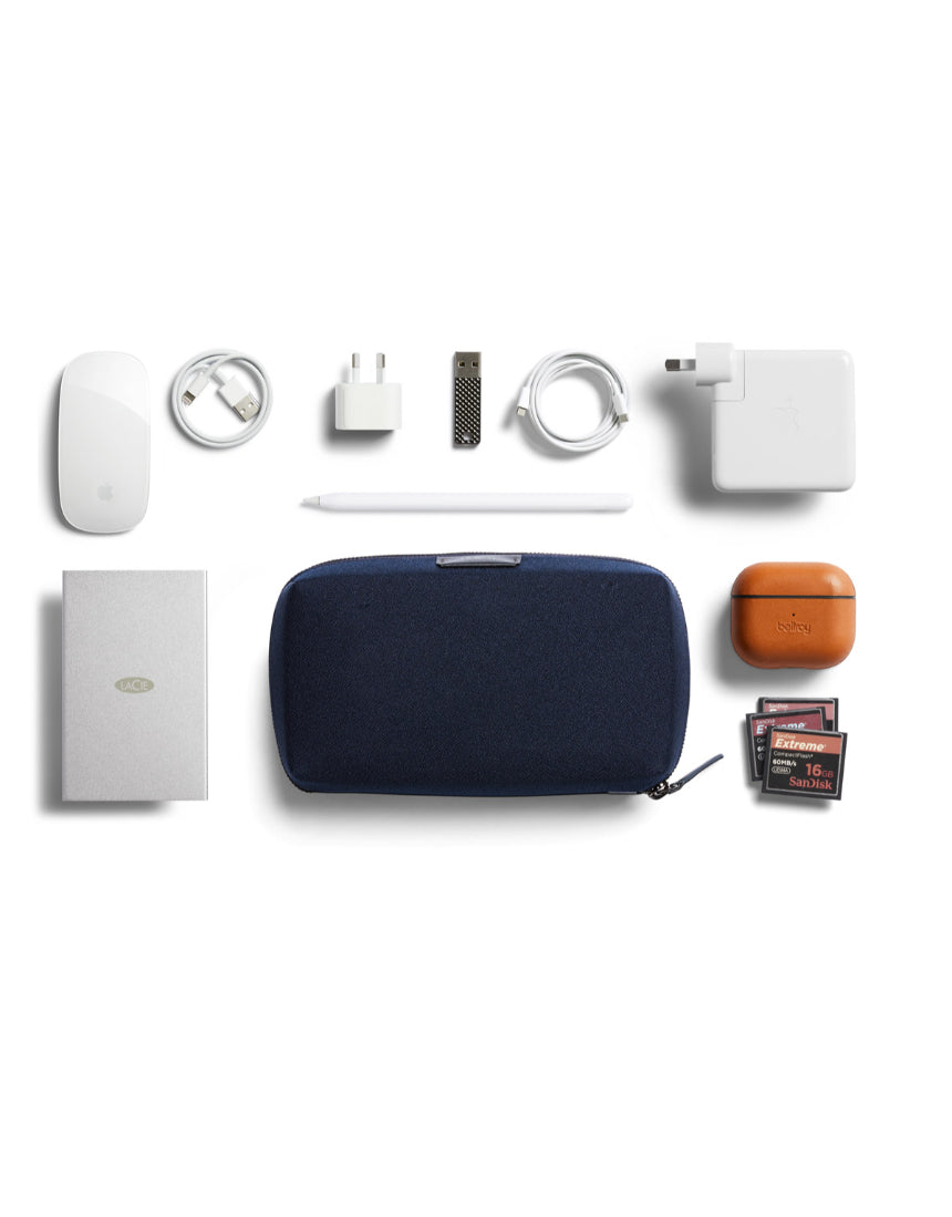 Bellroy Tech Kit in navy fabric with multiple compartments for organizing tech accessories and cables.