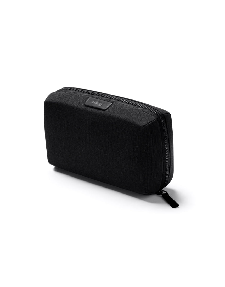 Bellroy Tech Kit in black with multiple compartments for organizing cables, chargers, and tech accessories.