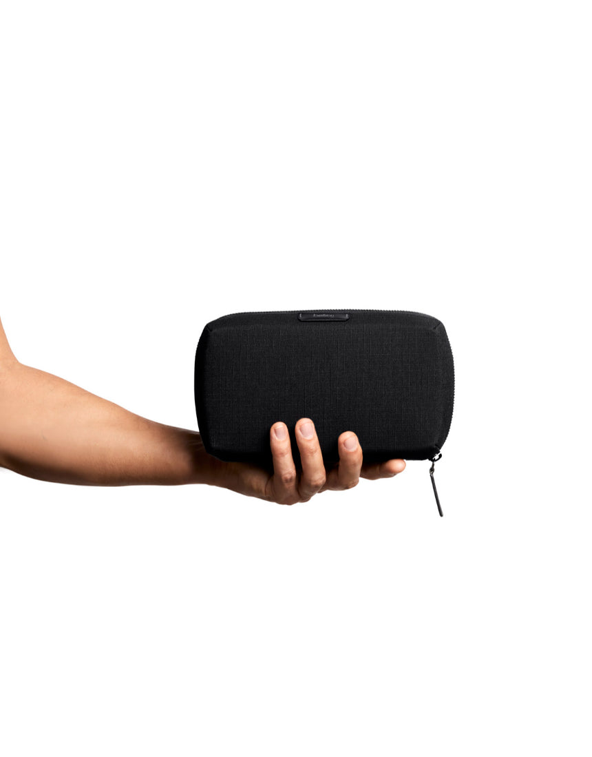 Bellroy Tech Kit in black showing organized compartments for cables, chargers, and tech accessories.