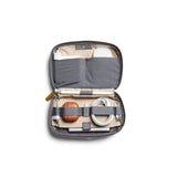 Bellroy Tech Kit in slate color, showing organized interior with multiple compartments for cables, chargers, and accessories.