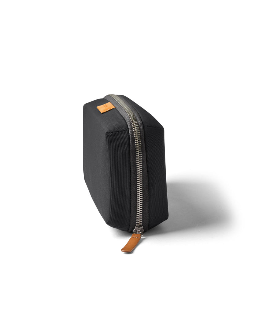 Bellroy Tech Kit in slate color, compact organizer with multiple compartments for cables and accessories, designed for travel and storage.