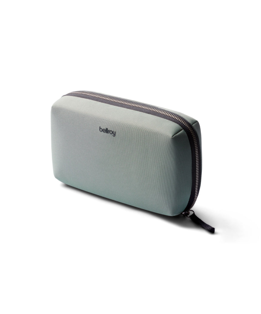 Bellroy Tech Kit in eucalyptus color with multiple compartments for organizing cables and accessories.