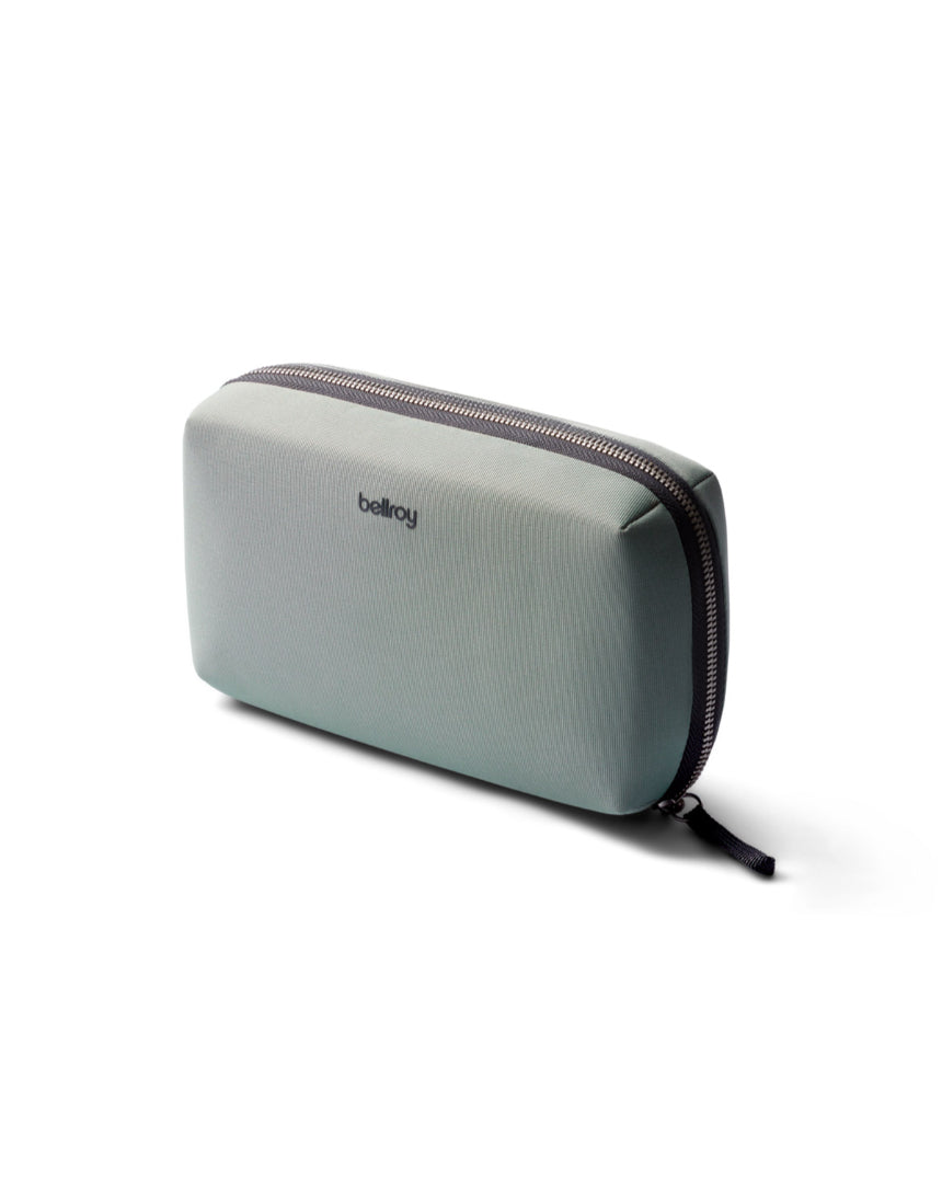 Bellroy Tech Kit in eucalyptus color with multiple compartments for organizing cables and accessories.