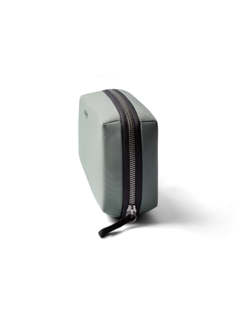 Bellroy Tech Kit in Eucalyptus with multiple compartments and zippers for organizing cables and accessories.