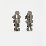 Gunmetal Elk Ozett Drop Earring with sleek, modern design featuring a smooth, elongated drop silhouette and subtle branding.