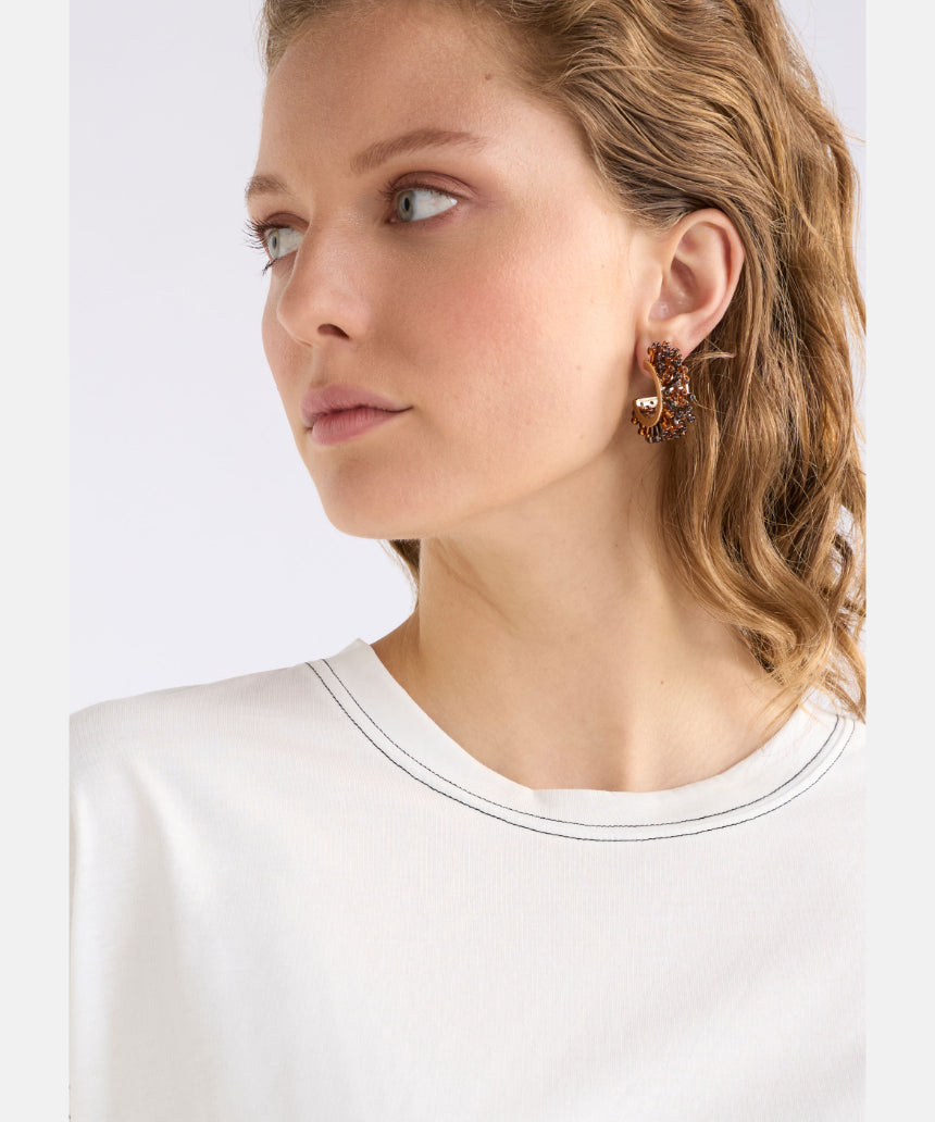 Elk Karan Small Hoop Earring in tortoiseshell with a smooth, rounded hoop design on a white background.