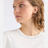 Elk Karan Small Hoop Earring in tortoiseshell with a smooth, rounded hoop design on a white background.