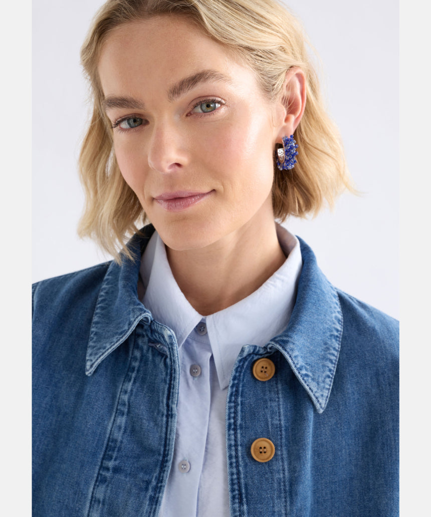 Elk Karan small hoop earrings with denim accents, showcasing a stylish and modern jewelry design.