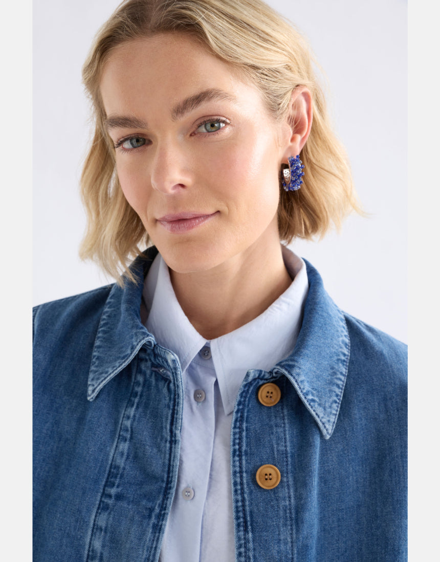 Elk Karan small hoop earrings with denim accents, showcasing a stylish and modern jewelry design.
