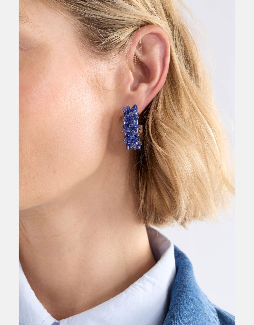 Elk Karan small hoop earrings in denim with a textured metal finish, featuring a simple circular hoop design.