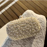 Olga Berg Valentina Pearl Clutch bag with sparkling pearl embellishments and elegant design, perfect for evening events.