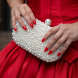 Olga Berg Valentina Pearl Clutch bag with pearl embellishments and sleek design, perfect for elegant occasions.
