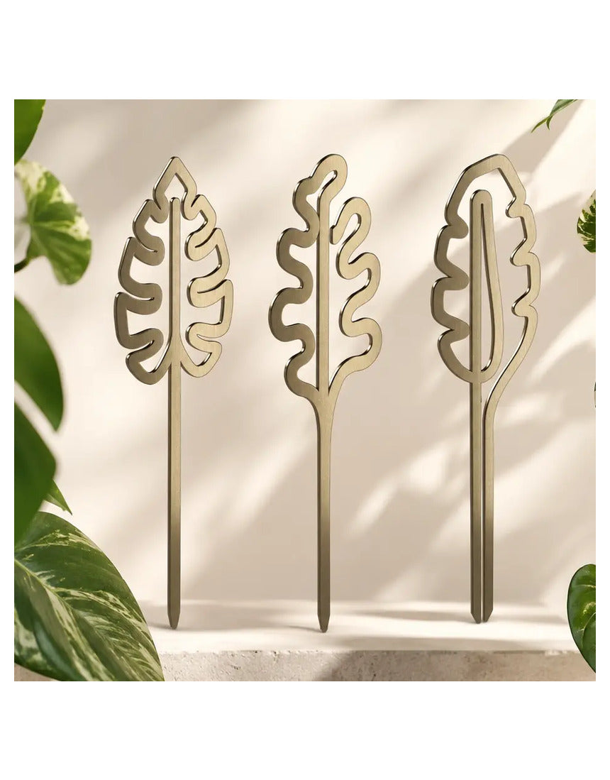 Brass plant grow pole by We The Wild, a stylish gardening accessory for supporting and training indoor plants.