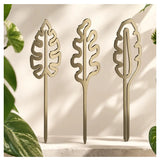 Brass plant grow pole by We The Wild, a stylish gardening accessory for supporting and training indoor plants.