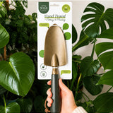 Green We The Wild hand trowel, a garden tool with a sturdy metal blade and ergonomic handle for planting and digging.