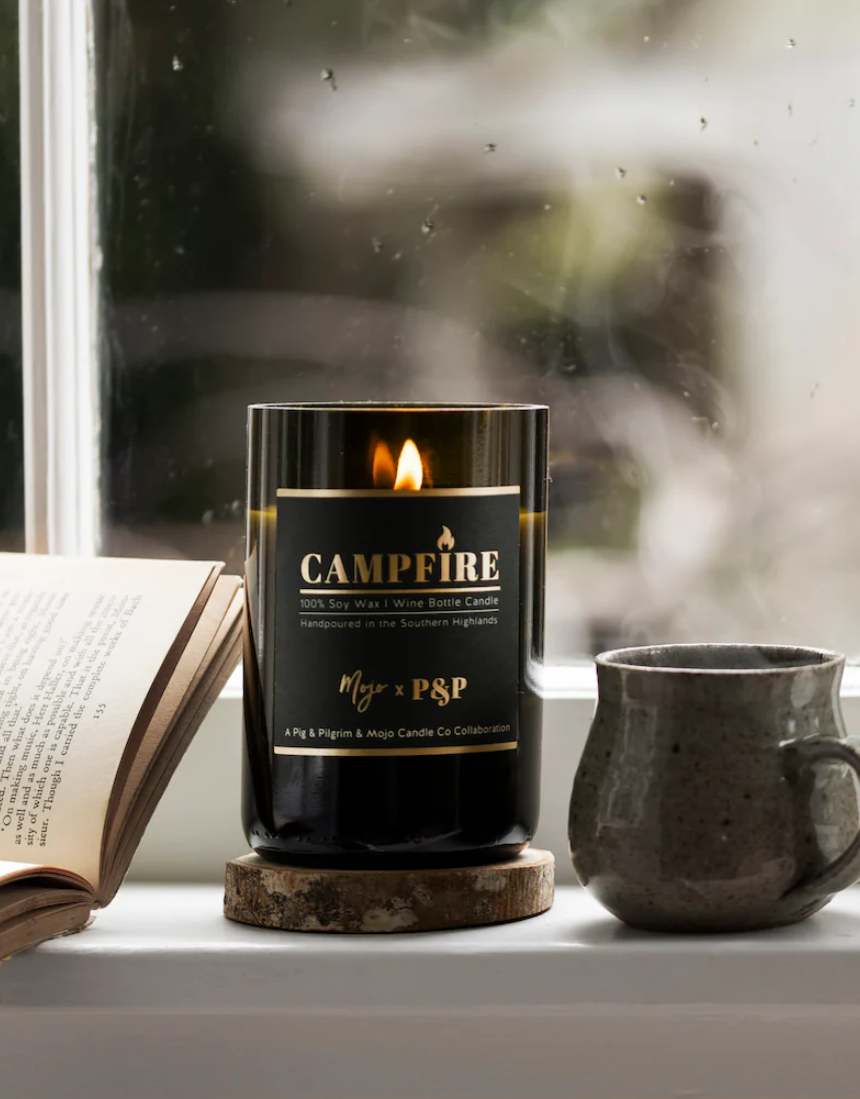 Mojo Candle Co. campfire scented candle in a glass jar with a wooden wick, ideal for cozy home ambiance.