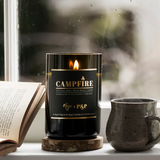Mojo Candle Co. campfire scented candle in a glass jar with a wooden wick, ideal for cozy home ambiance.