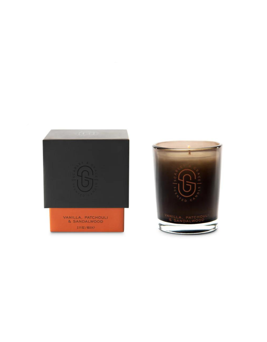 Scarlet & Grace vanilla, patchouli, sandalwood candle in 60g jar with a lit wick and a soft glow.