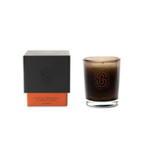 Scarlet & Grace vanilla, patchouli, sandalwood candle in 60g jar with a lit wick and a soft glow.