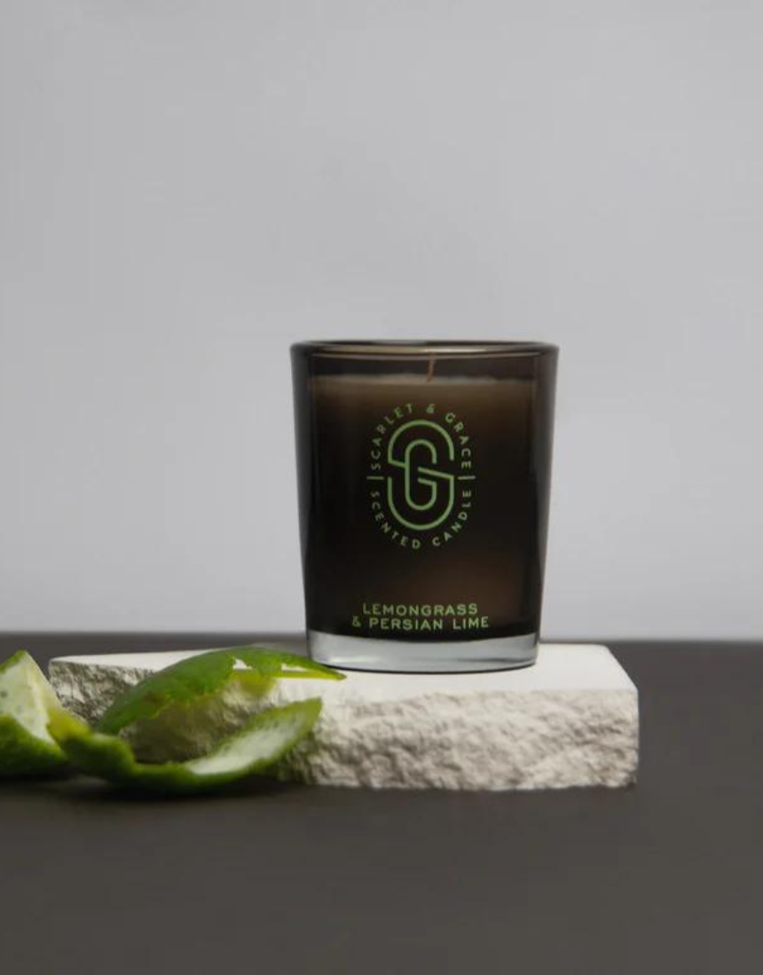 Scarlet & Grace Lemongrass and Persian Lime candle in a 60g jar, shown with fresh green lemongrass and lime slices.