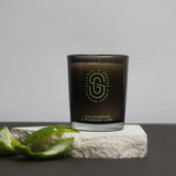 Scarlet & Grace Lemongrass and Persian Lime candle in a 60g jar, shown with fresh green lemongrass and lime slices.