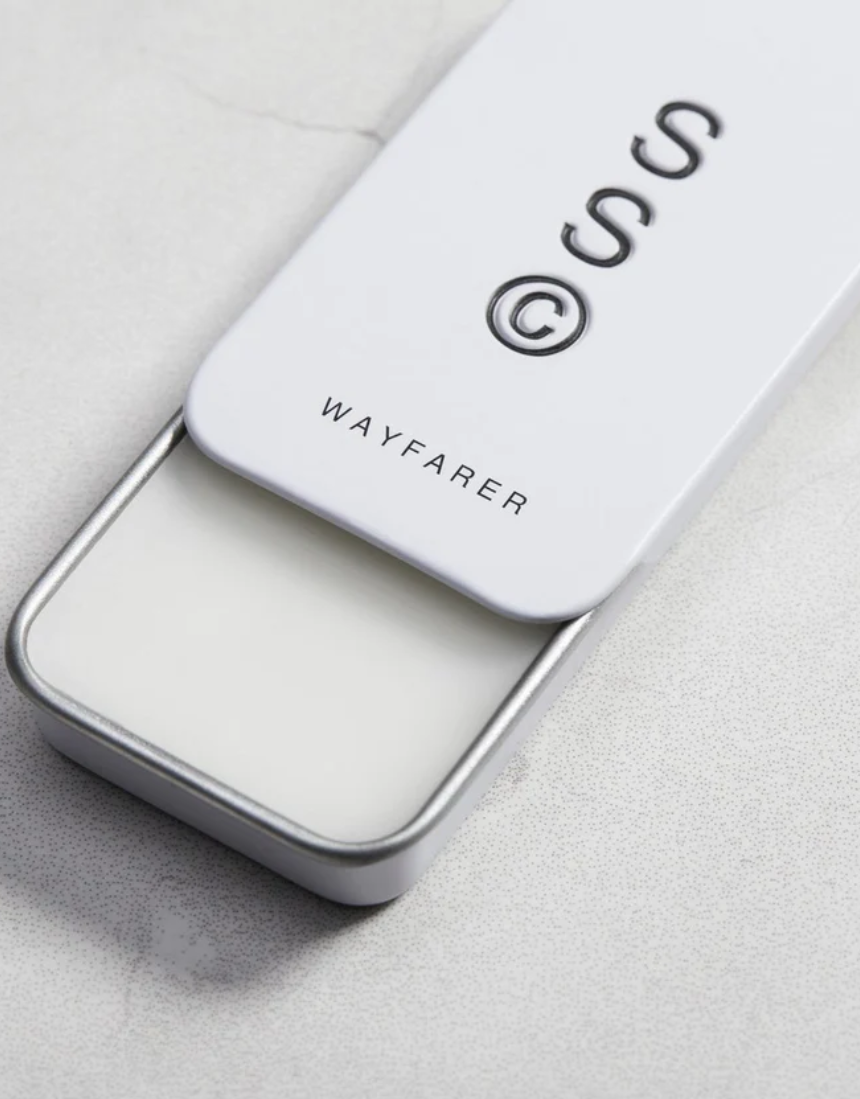 Solid State Wayfarer solid cologne in a sleek container, ready to be applied for a fresh, masculine scent.