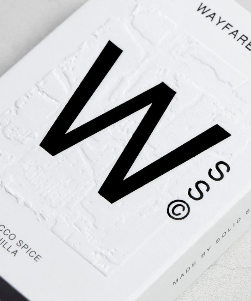 Solid State Wayfarer solid cologne in a sleek container, showcasing its minimalist design and modern branding.