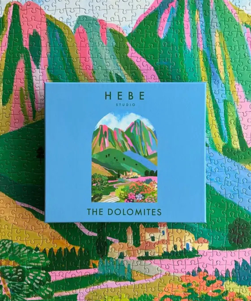 Hebe Studio The Dolomites 1000-piece puzzle featuring a scenic mountain landscape with colorful peaks and alpine scenery.