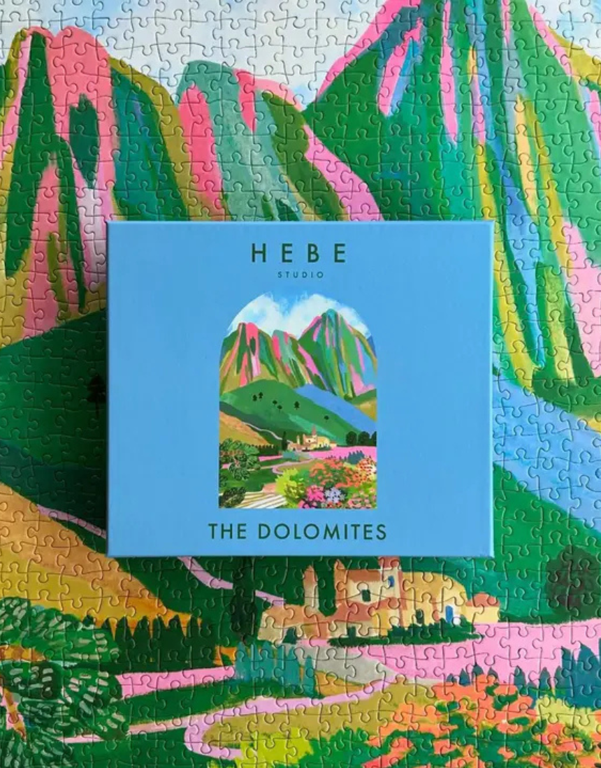Hebe Studio The Dolomites 1000-piece puzzle featuring a scenic mountain landscape with colorful peaks and alpine scenery.