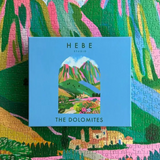 Hebe Studio The Dolomites 1000-piece puzzle featuring a scenic mountain landscape with colorful peaks and alpine scenery.