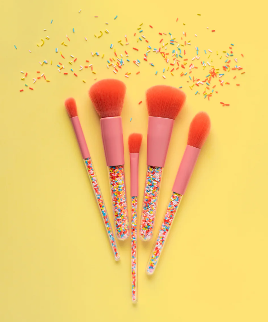 Kids makeup brush set by Oh Flossy with colorful handles and soft bristles, perfect for imaginative play and creative makeup application.