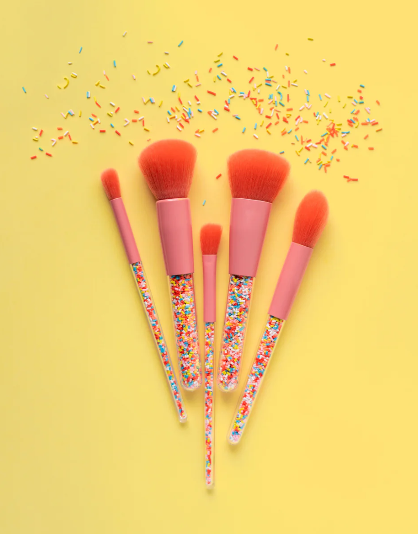 Kids makeup brush set by Oh Flossy with colorful handles and soft bristles, perfect for imaginative play and creative makeup application.