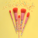Kids makeup brush set by Oh Flossy with colorful handles and soft bristles, perfect for imaginative play and creative makeup application.